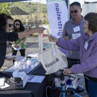 a woman giving a woman a bag
