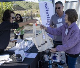 a woman giving a woman a bag
