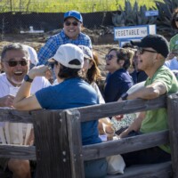 a group of people laughing on a wagon