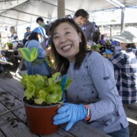 woman in gray smiling with butter lettuce