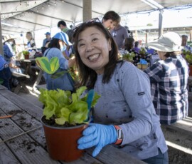 woman in gray smiling with butter lettuce