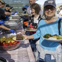 woman in blue with a plate of food