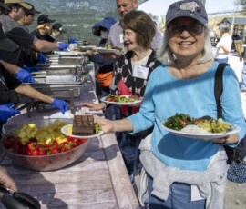 woman in blue with a plate of food