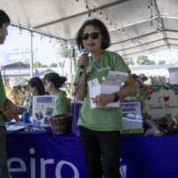 woman in green with a microphone