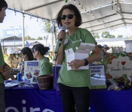 woman in green with a microphone