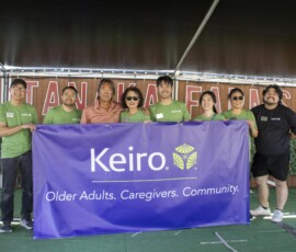 group of people behind a purple banner