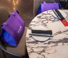purple bags by a white marble table