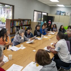 a group of people sitting by tables
