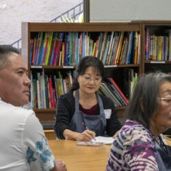 a woman in an apron writing notes