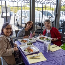 three woman posing with their food