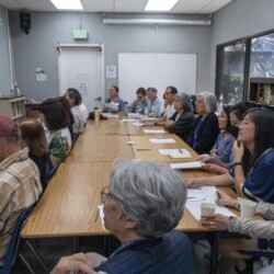 a group of people sitting by tables