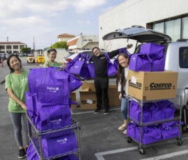 group of people with purple bags