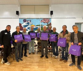 group of peopl with purple bags