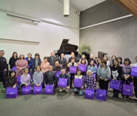 group of people with purple bags
