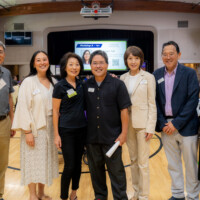board members and vip guests posing for the camera