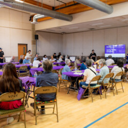 a group of people listening in on a workshop