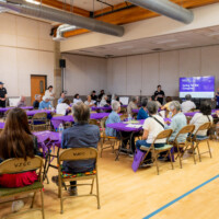 a group of people listening in on a workshop