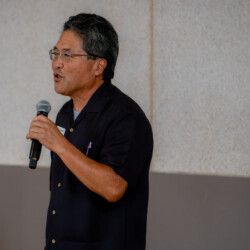 Rok Takasugi talking to a group of people