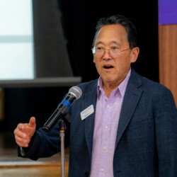 Jerry Iseda talking to a group of people