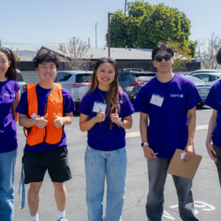 a group of volunteers in purple shirts