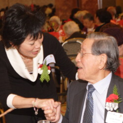 Beverly Ito shaking hands with George Aratani