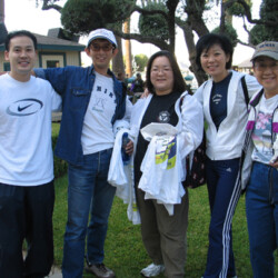 Beverly Ito smiling with a group of people, 2005