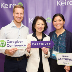 M PALMA PHOTO 2022 Beverly Ito holding caregiver signs with daughter and son in law