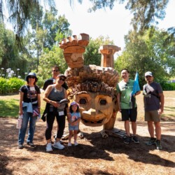 group photo of guests in front of a troll