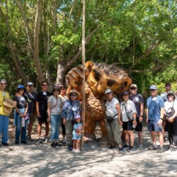 group photo of guests at Genki Living Workshops Walking in front a wooden troll