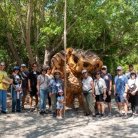 group photo of guests at Genki Living Workshops Walking in front a wooden troll
