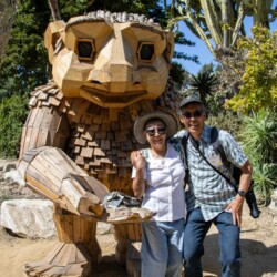 a man and woman standing next to a troll