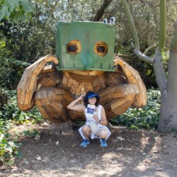 a woman squatting in front of a troll