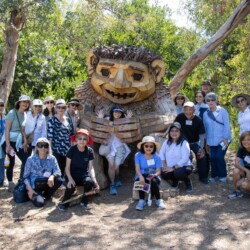 A group of people taking a photo in front of a troll