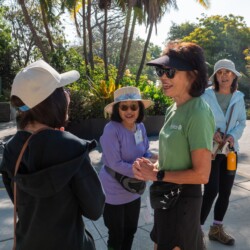 Beverly Ito smiling with a woman in a black sweater