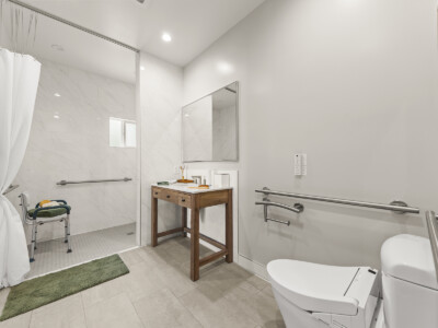 bathroom with toilet, sink, and ADA accessible bathroom