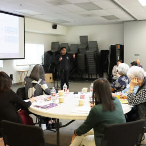 man presenting to a room of people