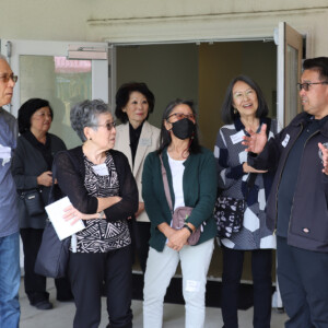man talking to a group of people standing