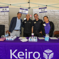 a group of people behind the purple table