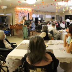 group of people dining while watching people play music