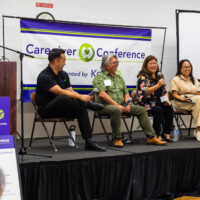 a group of panelists speaking on stage