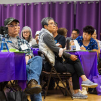 a group of people listening to the presentation