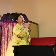 woman sining into microphone