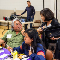 a woman with a basket talking with a man in green