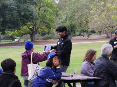 a man in black giving a woman in purple