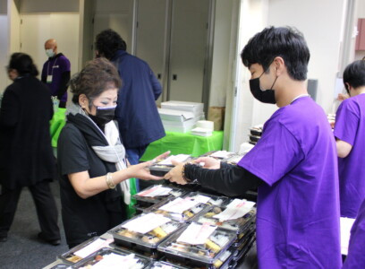man giving woman a bento