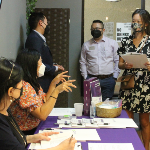 Attendee talking at registration table