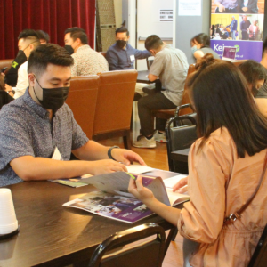 Attendees looking at papers at table