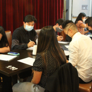 Attendees looking at papers on table