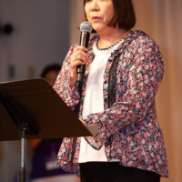 M PALMA PHOTO 2025 Kimiko Fujita speaking into microphone