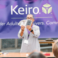 M PALMA PHOTO 2025 Bill Yamane holding up deck of cards for magic trick